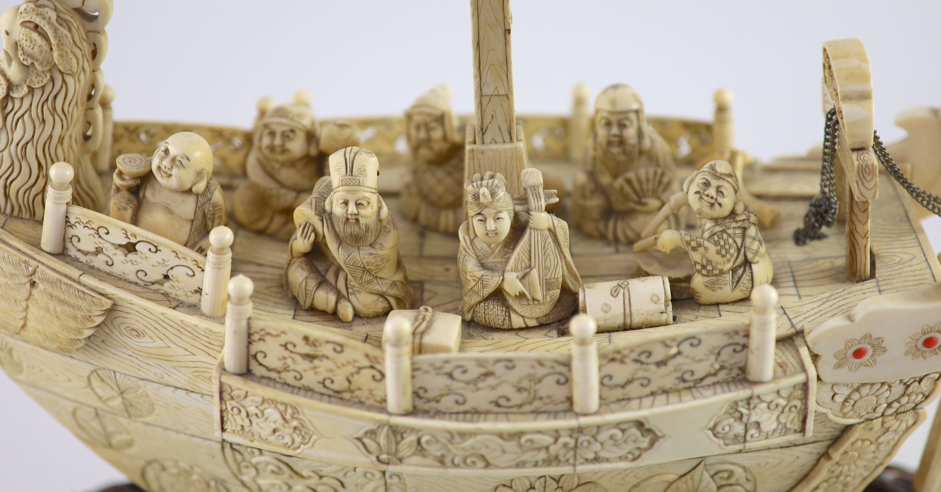 A large Japanese ivory okimono of the seven Gods of Happiness treasure ship the Takarabune, early Showa period, Total height 42 cm, length 41 cm, slight faults